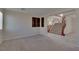 Cozy living room showcasing carpeted floors, natural light, and an open view of the staircase at 5912 Kit Cove Ct, Las Vegas, NV 89131