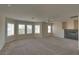 Spacious living room features natural light, plush carpet and fireplace at 5912 Kit Cove Ct, Las Vegas, NV 89131