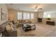A staged living room features a fireplace, multiple windows, and a comfortable sectional sofa at 5912 Kit Cove Ct, Las Vegas, NV 89131