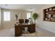 Inviting home office space with bookshelves, a large desk, and comfortable seating at 5912 Kit Cove Ct, Las Vegas, NV 89131