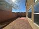 Small backyard featuring gravel, brick patio, brick wall and the side of the house at 6093 Crown Palms Ave, Las Vegas, NV 89139