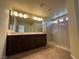 Bright Primary bathroom with double sinks, large mirror, and tiled glass shower at 6093 Crown Palms Ave, Las Vegas, NV 89139