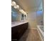 Bathroom featuring dual sinks, granite countertops, and shower-tub combo at 6093 Crown Palms Ave, Las Vegas, NV 89139