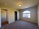 Bedroom featuring carpet, neutral walls, standard ceiling light, closet and arch window at 6093 Crown Palms Ave, Las Vegas, NV 89139