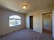 Bedroom featuring carpet, neutral walls, standard ceiling light, closet and arch window at 6093 Crown Palms Ave, Las Vegas, NV 89139