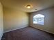 Bedroom featuring carpet, neutral walls, standard ceiling light and arch window at 6093 Crown Palms Ave, Las Vegas, NV 89139