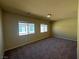 Spacious bedroom with carpet, neutral walls, and plenty of natural light from two windows at 6093 Crown Palms Ave, Las Vegas, NV 89139
