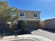 Two-story home featuring a two-car garage and low maintenance front yard with stone accents at 6093 Crown Palms Ave, Las Vegas, NV 89139