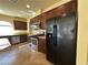 Updated kitchen featuring dark cabinets, granite countertops, stainless steel appliances, and a center island at 6093 Crown Palms Ave, Las Vegas, NV 89139