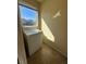 Bright laundry area with a white dryer, tile flooring, and window at 6093 Crown Palms Ave, Las Vegas, NV 89139
