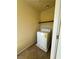 Cozy laundry room featuring a white washing machine and shelf at 6093 Crown Palms Ave, Las Vegas, NV 89139