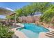Sparkling pool and patio area surrounded by lush landscaping, creating a private oasis for relaxation and entertainment at 6329 Orange Hue St, North Las Vegas, NV 89031