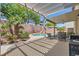 Outdoor living with covered patio, lush landscaping, charming pool, and BBQ area perfect for relaxing and entertaining at 6329 Orange Hue St, North Las Vegas, NV 89031