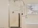 Shower and tub area with glass door and chrome fixtures with a window at 6329 Orange Hue St, North Las Vegas, NV 89031