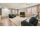 Spacious living room with plush seating, carpet flooring, and bright natural light at 6329 Orange Hue St, North Las Vegas, NV 89031