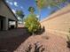 The backyard features a brick patio surrounded by stone and trees offering a serene outdoor oasis at 640 House Blend Ln, Henderson, NV 89052