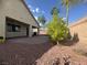 A spacious backyard with a brick patio and lush landscaping, designed for relaxation and entertainment at 640 House Blend Ln, Henderson, NV 89052