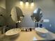 Dual vessel sinks and granite countertops add a modern touch to this bright bathroom at 640 House Blend Ln, Henderson, NV 89052