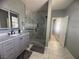 Stylish bathroom with marble floors, glass shower, and gray vanity at 640 House Blend Ln, Henderson, NV 89052