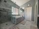 Modern bathroom featuring a soaking tub with marble surround, walk-in shower, and tiled floors at 640 House Blend Ln, Henderson, NV 89052