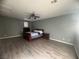 Spacious bedroom with wood-look flooring, ceiling fan, and abundant natural light at 640 House Blend Ln, Henderson, NV 89052
