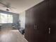 This bedroom has wood floors, a ceiling fan, closet, and a large window at 640 House Blend Ln, Henderson, NV 89052