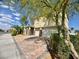 Two-story home showcasing a two-car garage, brick driveway, and beautiful landscaping at 640 House Blend Ln, Henderson, NV 89052