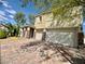Beautiful two-story home shows a tile roof, desert landscaping, and a three-car garage at 640 House Blend Ln, Henderson, NV 89052