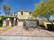 Charming two-story home boasts a tile roof, brick driveway, and a three-car garage at 640 House Blend Ln, Henderson, NV 89052