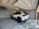 A well-kept garage featuring epoxy flooring, a parked vehicle, and ample space for storage at 640 House Blend Ln, Henderson, NV 89052