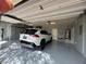 A spacious garage with epoxy flooring, storage cabinets, and a parked vehicle for convenience at 640 House Blend Ln, Henderson, NV 89052
