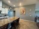 Kitchen island with sink, countertop seating, and white cabinets at 640 House Blend Ln, Henderson, NV 89052