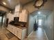 Updated kitchen with granite countertops and an arched entryway to the front hall at 640 House Blend Ln, Henderson, NV 89052