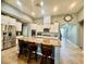 Stylish kitchen with a large island, seating, stainless steel appliances and white cabinets at 640 House Blend Ln, Henderson, NV 89052