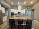 Bright kitchen with a large island, seating, and white cabinets at 640 House Blend Ln, Henderson, NV 89052