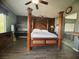 Spacious main bedroom with hardwood floors, built in desk, and view to the ensuite bath with tub at 640 House Blend Ln, Henderson, NV 89052