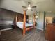 Spacious main bedroom featuring a four poster bed, hardwood floors, and an ensuite bathroom at 640 House Blend Ln, Henderson, NV 89052