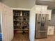 Walk-in pantry is fully stocked with ample storage next to a stainless steel refrigerator at 640 House Blend Ln, Henderson, NV 89052