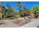 Backyard patio with outdoor seating and dining surrounded by lush landscaping at 6409 Sea Swallow St, North Las Vegas, NV 89084