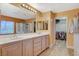 Large bathroom featuring a double sink vanity, soaking tub, and walk-in closet at 6409 Sea Swallow St, North Las Vegas, NV 89084