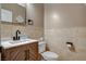 Well-lit bathroom with decorative herringbone cabinet, contemporary fixtures, and tile walls at 6409 Sea Swallow St, North Las Vegas, NV 89084