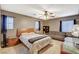 Bright bedroom with large windows, ceiling fan, and seating area at 6409 Sea Swallow St, North Las Vegas, NV 89084