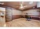Well-lit bonus room features hardwood floors, built-in shelves, and a barn door at 6409 Sea Swallow St, North Las Vegas, NV 89084