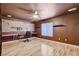 Versatile bonus room with hardwood floors, ceiling fan, and custom shelving at 6409 Sea Swallow St, North Las Vegas, NV 89084