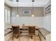 Bright breakfast nook with travertine tile flooring, built-in bench, and stylish lighting at 6409 Sea Swallow St, North Las Vegas, NV 89084