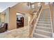 Inviting entryway with tile flooring, staircase, and views of the office space at 6409 Sea Swallow St, North Las Vegas, NV 89084
