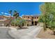 Two-story home with desert landscaping, mature trees, and spacious driveway, offering a welcoming curb appeal at 6409 Sea Swallow St, North Las Vegas, NV 89084