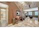 Elegant foyer featuring tile flooring, a staircase with wrought iron railings, and a view into the living room at 6409 Sea Swallow St, North Las Vegas, NV 89084