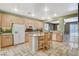 Bright kitchen featuring an island, stainless appliances, and tiled floors at 6409 Sea Swallow St, North Las Vegas, NV 89084