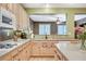 Bright kitchen boasts light wood cabinetry, modern appliances, and ample counter space at 6409 Sea Swallow St, North Las Vegas, NV 89084
